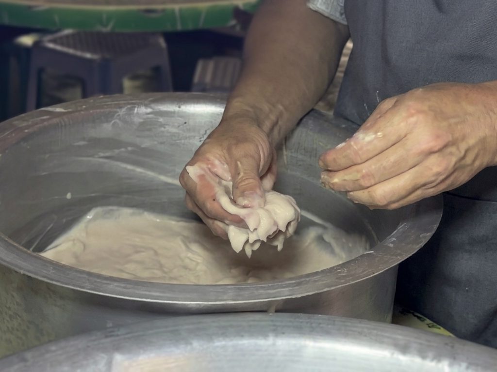 Shaping a fish ball by hand